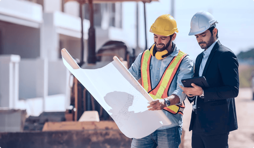 Engineering team reviewing blueprints